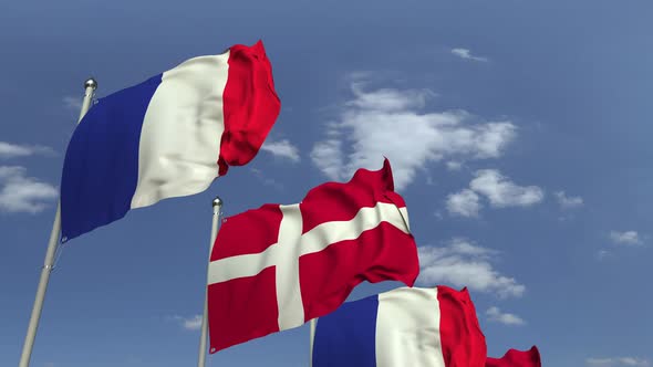 Waving Flags of Denmark and France on Sky Background alt