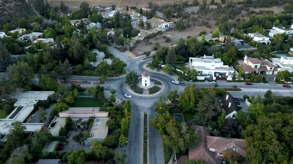 Aerial dolly in lowering on Leonidas Montes windmill in roundabout with vehicles commuting surrounde