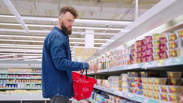 Customer Buying Yogurt in the Supermarket