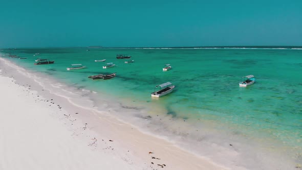 Boats are Anchored Off the Coast on Shallow Ocean at Low Tide Aerial Zanzibar