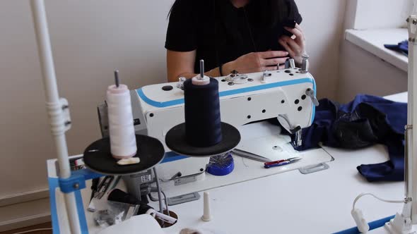 A Young Woman Prepares Cloth for Sewing with Sewing Machine