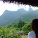 Rear view of a female traveler looking at a beautiful mountains view - VideoHive Item for Sale