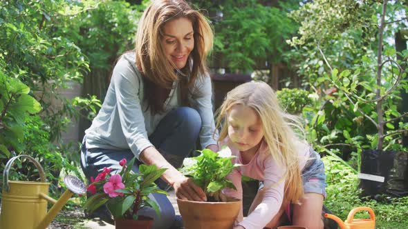 Mother and daughter are replanting in the garden