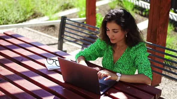 Caucasian Woman Working with Laptop Computer Outside Office