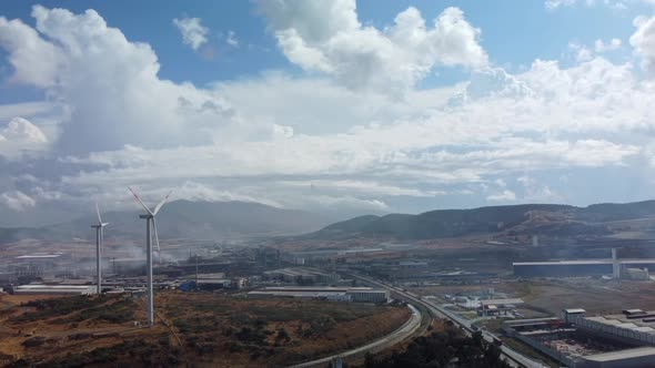 Aerial View of Pollution of the Environment a Pipe with Smoke and Wind Turbines