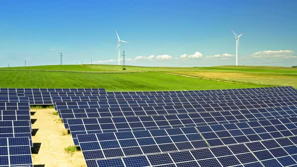 Solar panels, wind turbines and green field, aerial view, Poland