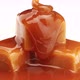 Melted caramel sauce flowing on caramel candies close up - VideoHive Item for Sale