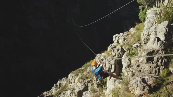 Young Caucasian man zip lining