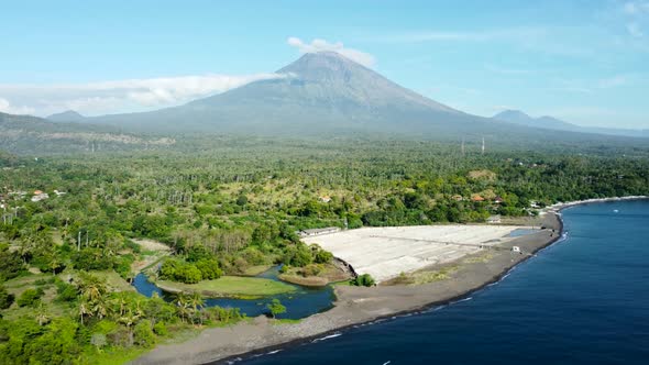 Fly Along Black Sand Beach with Volcano Mountains