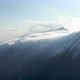 Clouds slide down the mountains like a waterfall in the Swiss Alps, Switzerland. - VideoHive Item for Sale