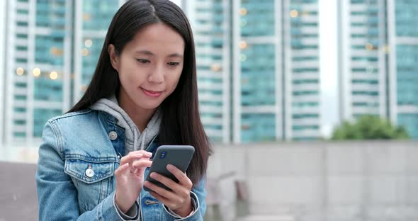 Young woman work on cellphone at outdoor