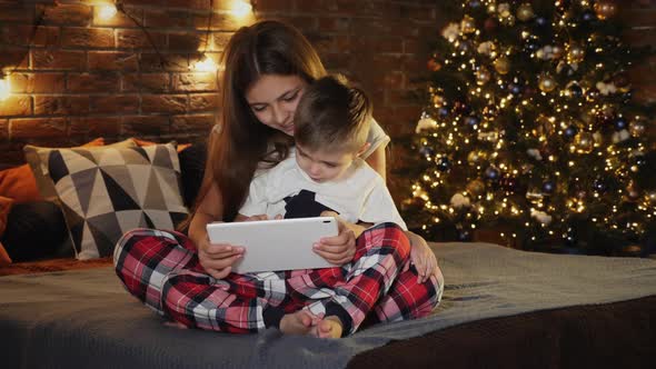 Children Use a Digital Tablet Computer in the Bedroom