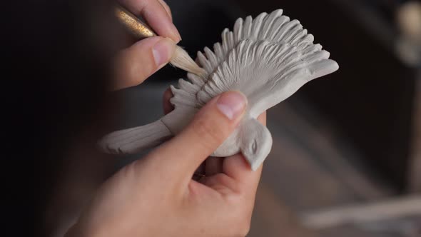 Close Up Portrait of Potter Woman Hands Working on Details of a Clay Handcraft Bird