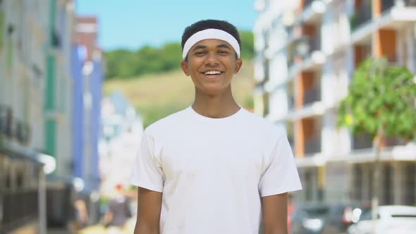 Happy Mixed-Race Teen Athlete With Headband Smiling on Cam, Wellness and Health