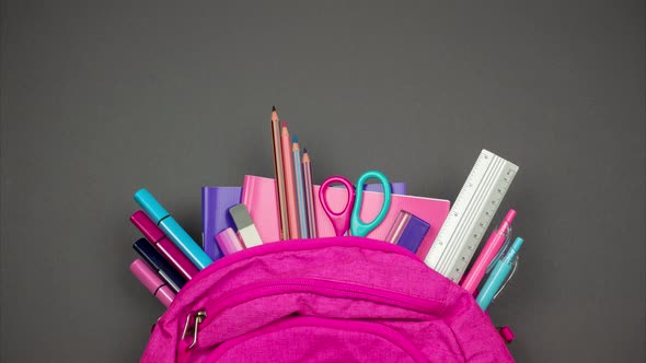  Partly view backpack with sticking out school supplies. Stop motion