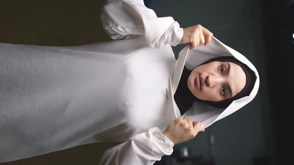 Portrait of a Young Muslim Woman in a White Hijab a Woman Posing in Front of the Camera in the Gym