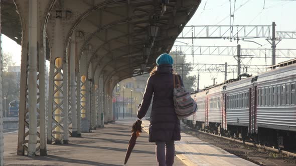 Female Walking Along Platform of Railway Station