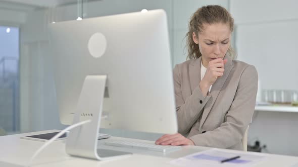 Sick Young White Businesswoman Coughing in Office