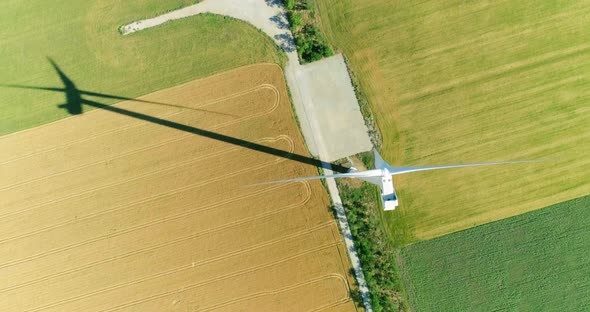 Windmill for electric power production in the agricultural fields. View from above.