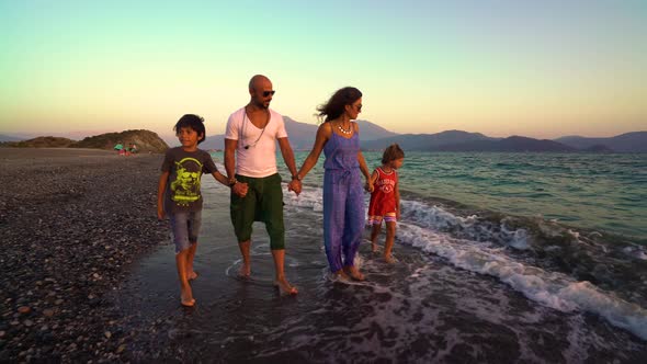 Family Walks On The Beach