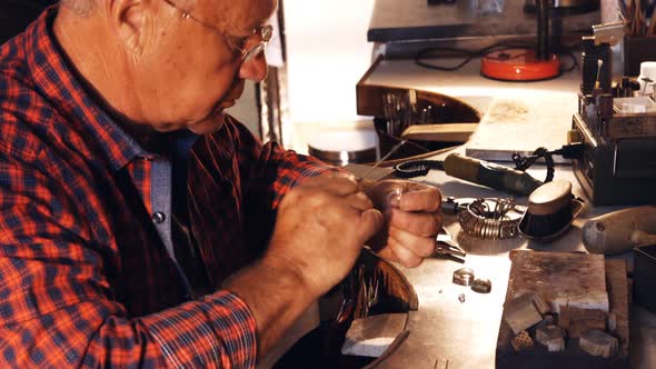 Goldsmith fixing diamond on ring