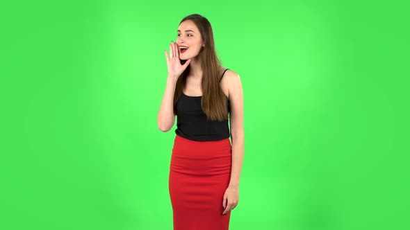 Girl Screams Calling Someone on a Green Screen at Studio