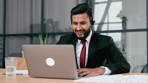 Successful Confident Indian or Arabian Businessman Company Ceo with Headset Look at Laptop Screen