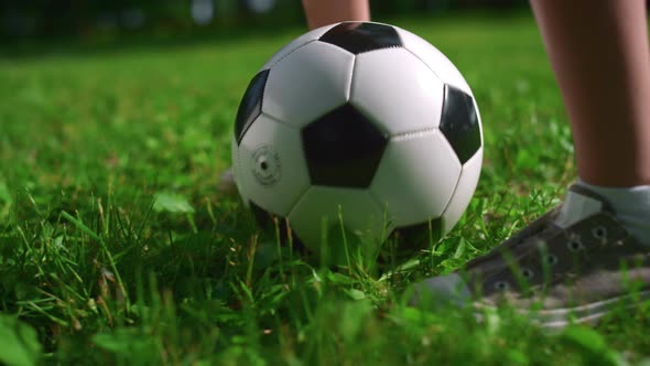 Unknown Kids Feet Playing Football on Grass Close Up