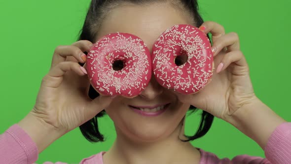 Happy Beautiful Young Girl Posing and Having Fun with Donuts. Chroma Key