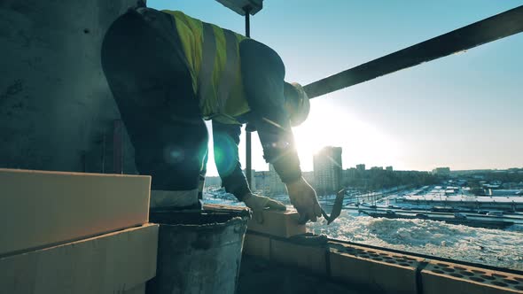 Builder Lays Bricks on Construction Site