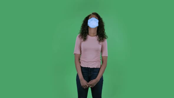 Portrait of Beautiful African American Young Woman in Medical Mask Is Upset and Tired Looking