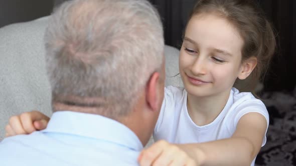 Family Portrait of Mature Father and Little Blonde Daughter Hugging at Home While Celebrating Father