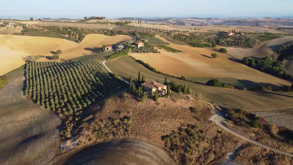 Val d'Orcia Rolling Hills and Farmhouse in Countryside Tuscany Aerial View