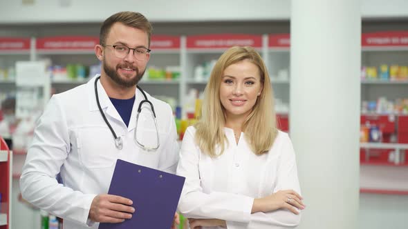 Portrait of Two Beautiful Pharmacist in Uniform at Modern Drugstore