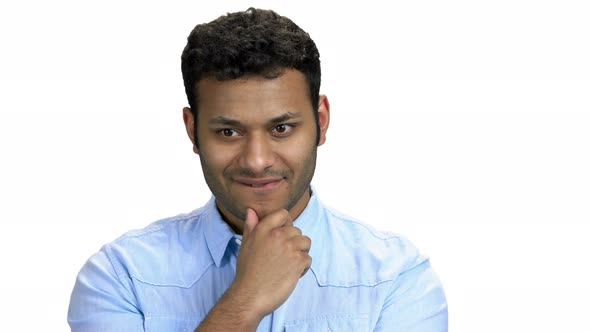 Young Man with Thoughtful Expression on White Background