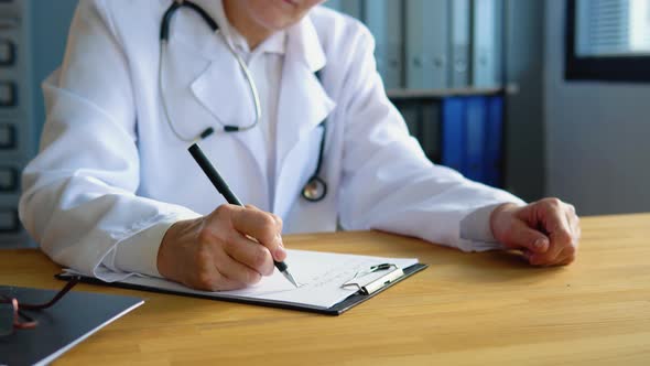 Close Up Wrinkled Female Hands Writing Information in Medical Registration Journal