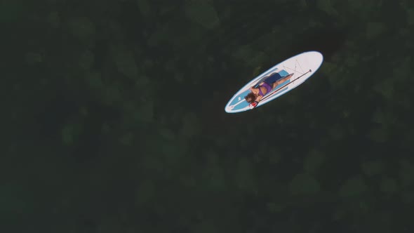 Woman Practicing Gymnastics on Sup Board