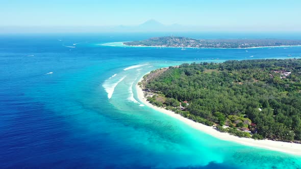 Aerial flying over nature of perfect island beach wildlife by blue water and white sandy background 