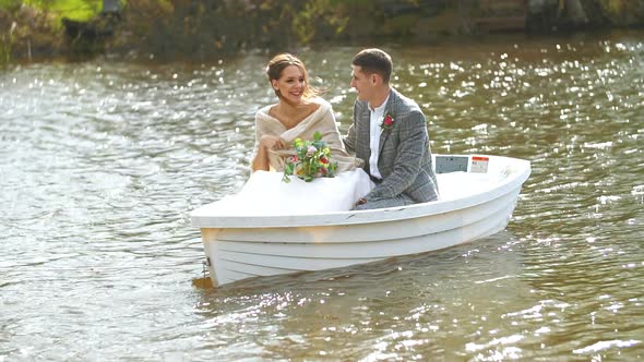 Happy Husband and Wife Are Sitting in a Boat and Laughing at Their Joyful Life