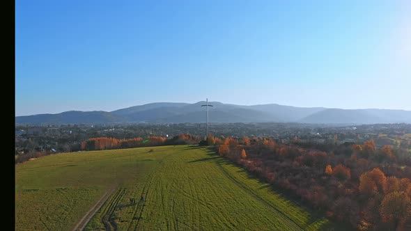 Fly over cross and three lipki spot in in Bielsko Biala City. Tilt up. Push in.