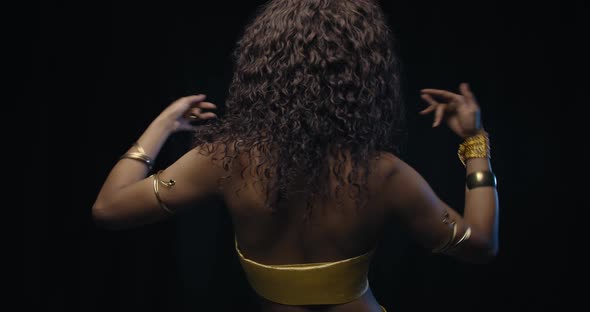 View From the Back on a Young Woman Belly Dancing Curly Hair