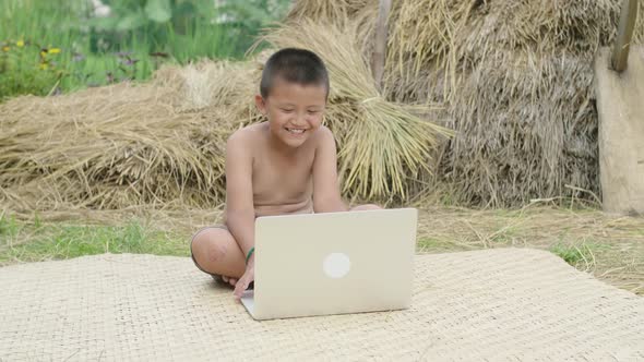 Happy Rural Boy Playing Computer alt