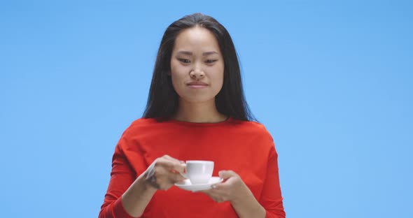 Young Woman Drinking Coffee