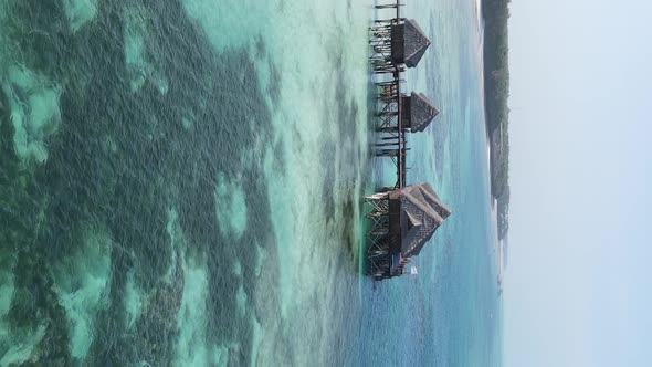 Vertical Video House on Stilts in the Ocean on the Coast of Zanzibar Tanzania Aerial View