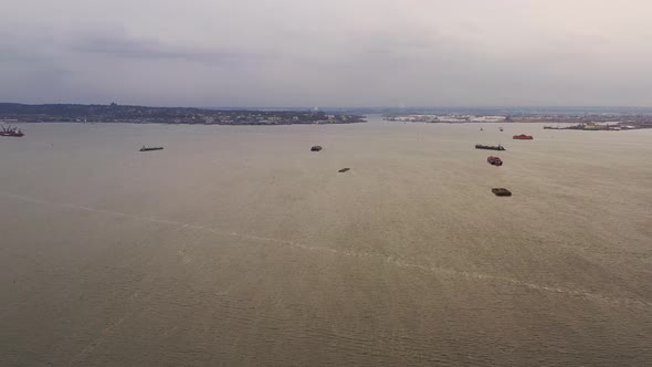 a high aerial drone shot, panning right over Brooklyn's Bush Terminal Park on a cloudy day. In the w