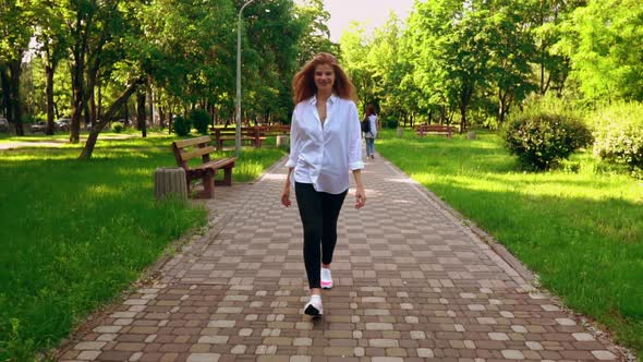 Happy Female Walk in Park