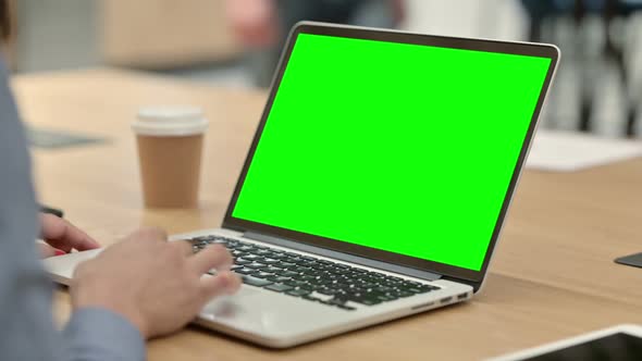 African Woman Using Laptop with Green Chroma Key Screen