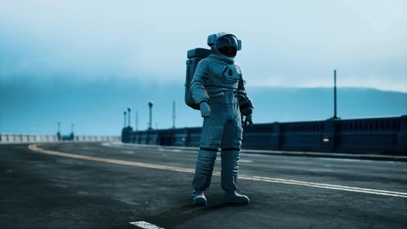 Astronaut in Space Suit on the Road Bridge alt