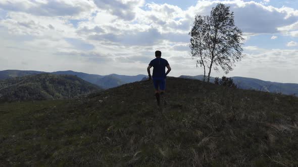 Athlete Running on a Mountain Trail. Skyrunner Trains Outdoors alt