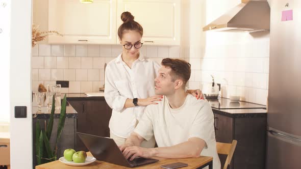 Married Couple Use Their Own Laptop for Developing Business, They Are at Freelance.